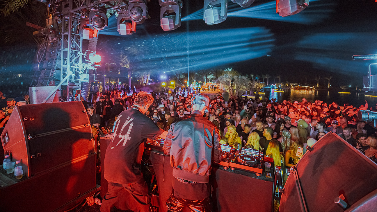 Crowd watching DJs perform at TAO Group Hospitality's Desert Nights Coachella party in 2023